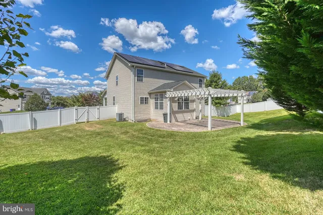 a view of a chair and table in backyard