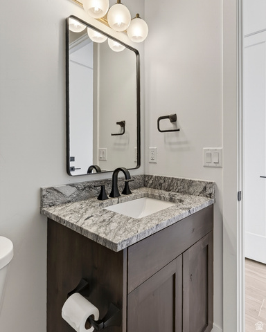 2862 South Mountain Rnch Road Cedar City, UT 84720 - Photo 49 of 64 Powder room featuring a dark wood-finish vanity with a light-toned granite countertop and an undermount sink