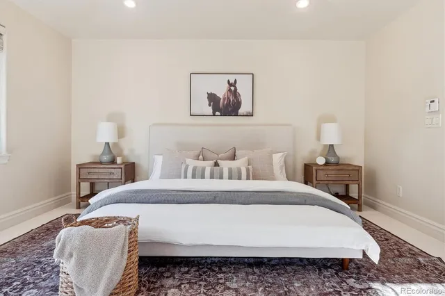 a bedroom with a bed a rug and a lamp