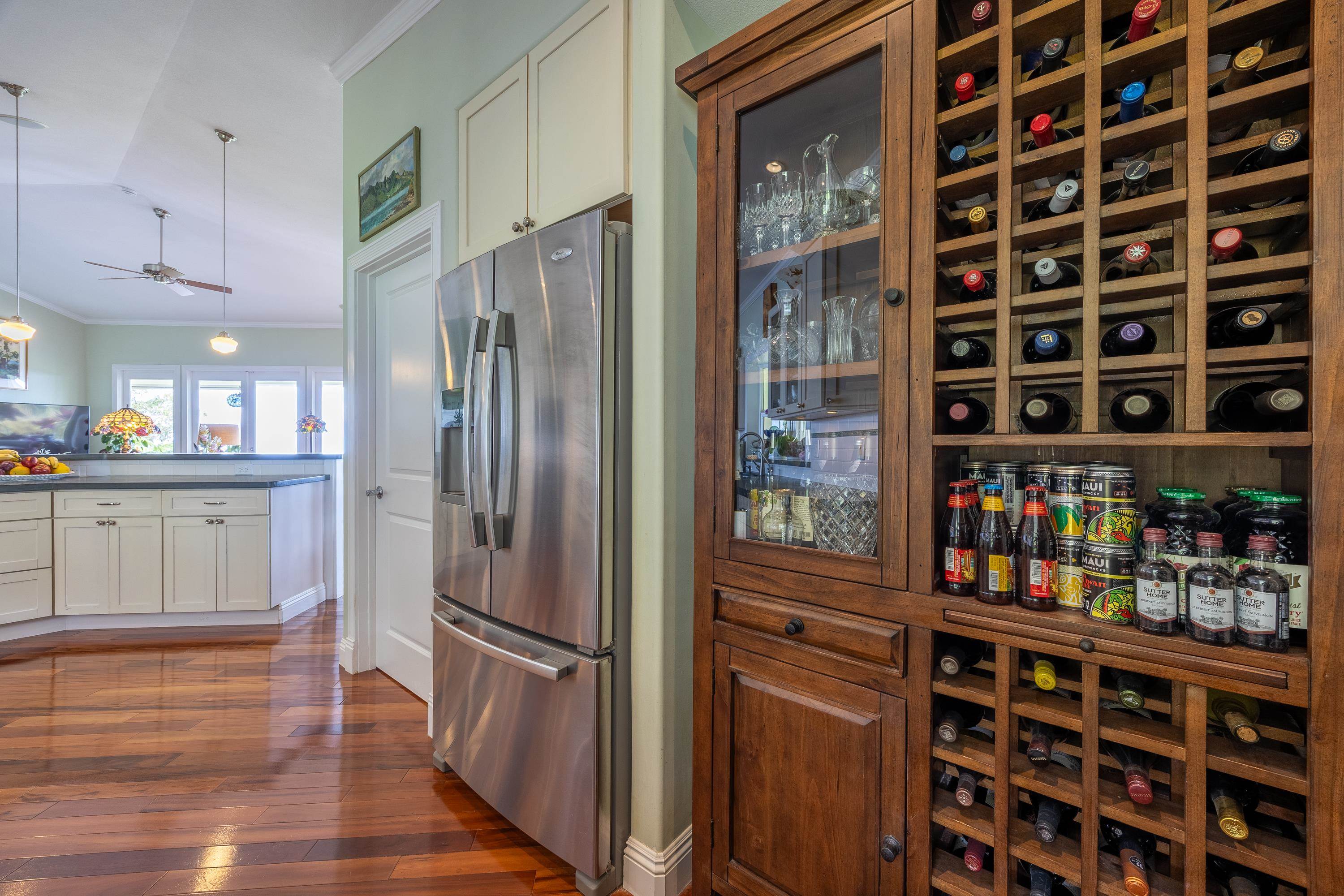 980 Polipoli Road Kula, HI 96790 - Photo 15 of 50 a kitchen with stainless steel appliances a refrigerator and wooden floor