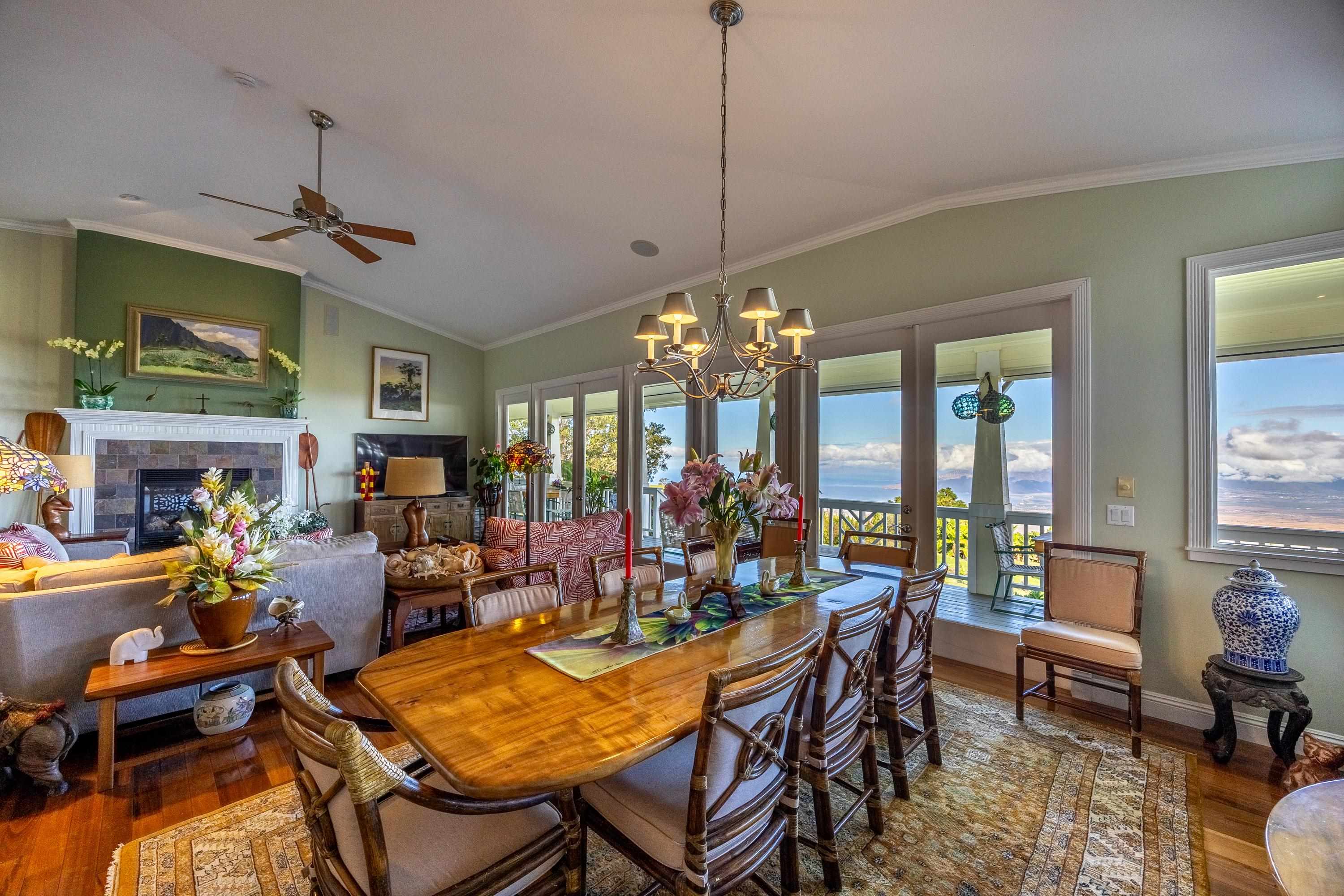 980 Polipoli Road Kula, HI 96790 - Photo 8 of 50 a view of a dining room with furniture a chandelier and large windows