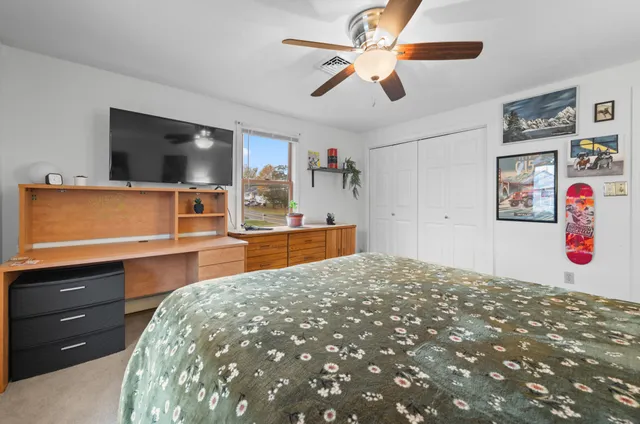 a bedroom with a bed and a flat screen tv