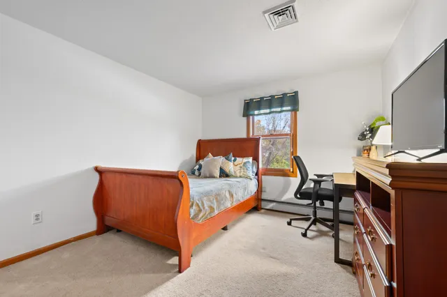 a bedroom with a bed and a chair