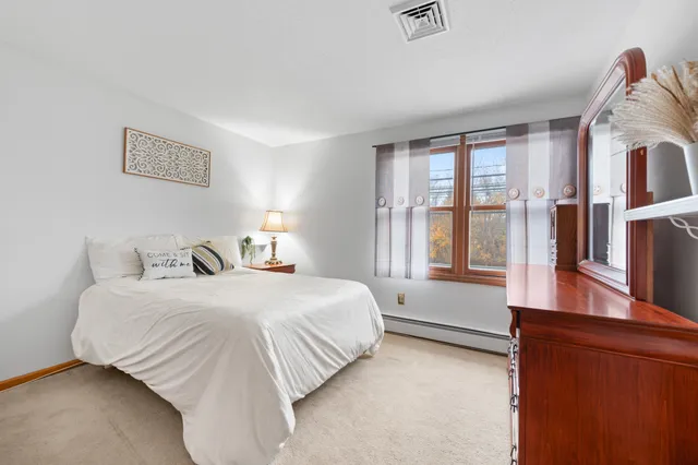 a bedroom with a large bed and a large window