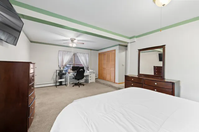 a bedroom with a bed and a large window