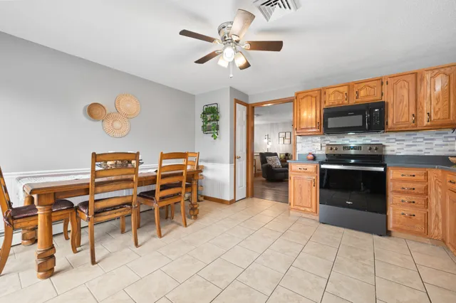 a kitchen with stainless steel appliances a stove a sink and a refrigerator