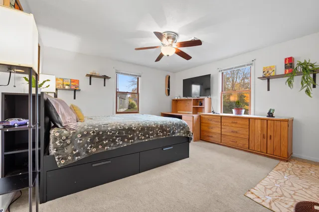 a bedroom with a large bed and a chandelier