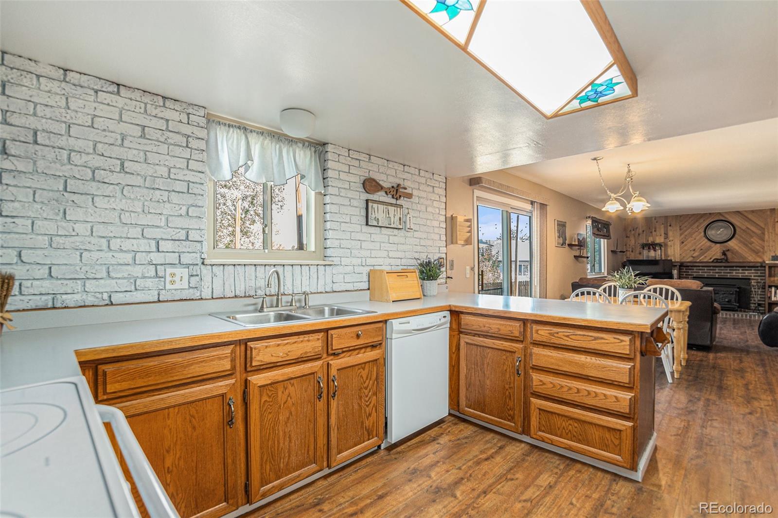 10110 Oak Street Westminster, CO 80021 - Photo 13 of 40 a kitchen with stainless steel appliances granite countertop a sink and cabinets