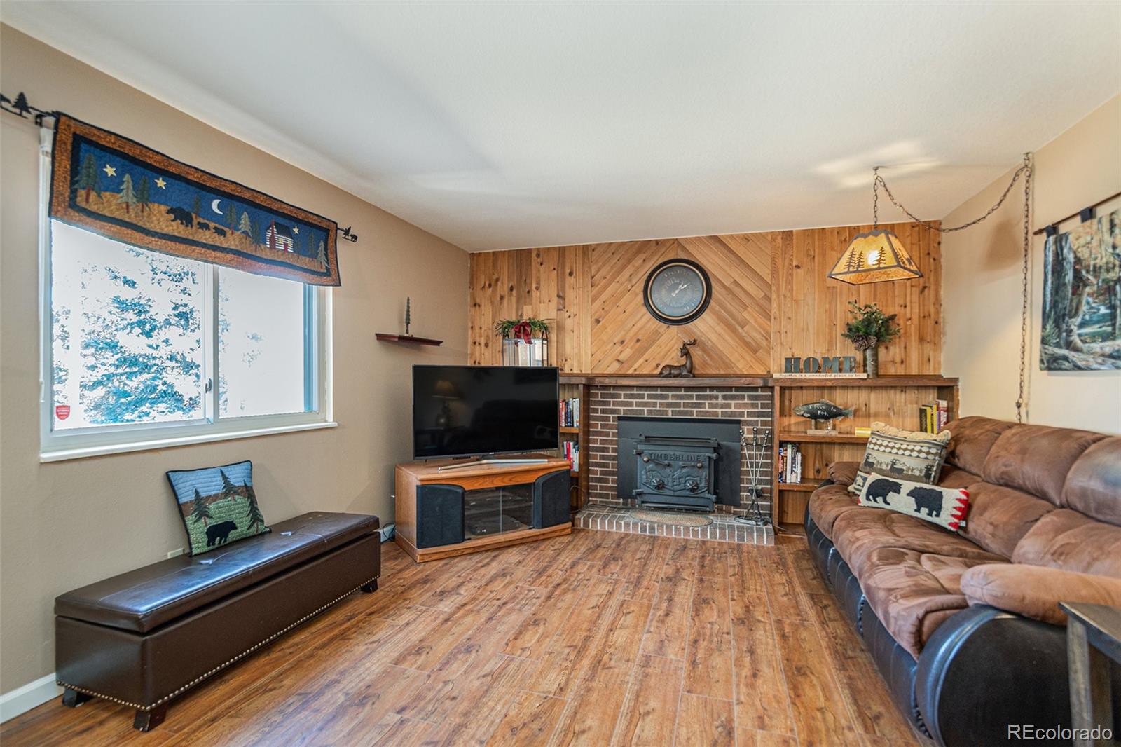 10110 Oak Street Westminster, CO 80021 - Photo 14 of 40 a living room with furniture a fireplace and a flat screen tv