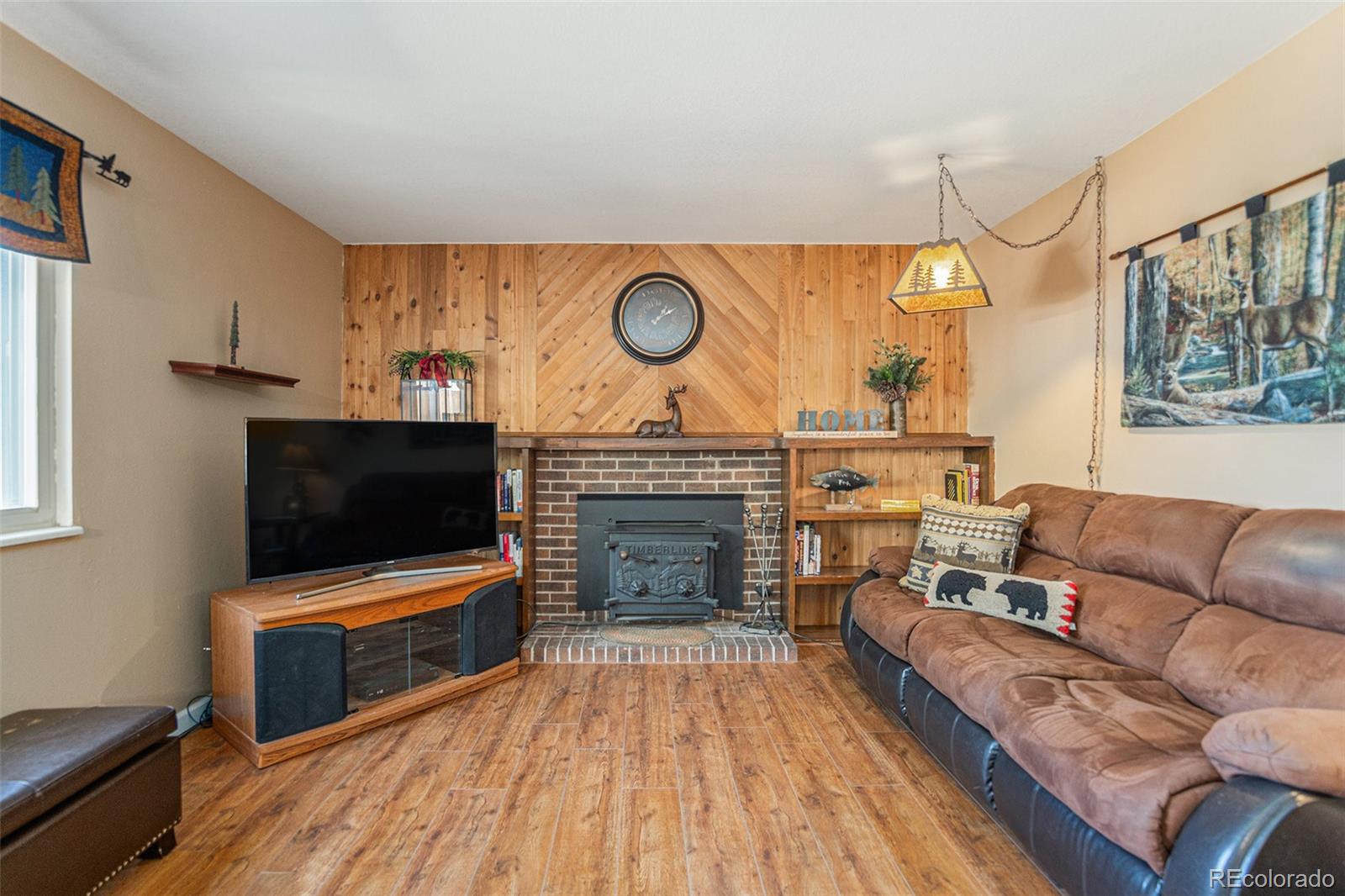 10110 Oak Street Westminster, CO 80021 - Photo 15 of 40 a living room with furniture a flat screen tv and a fireplace