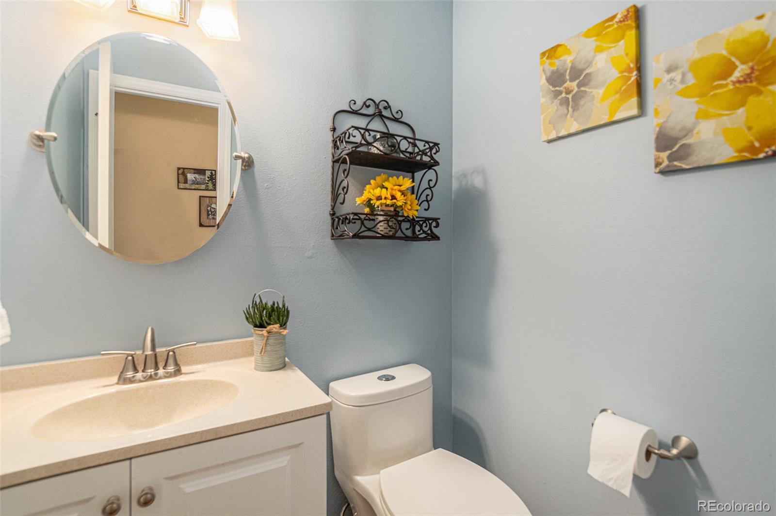 10110 Oak Street Westminster, CO 80021 - Photo 16 of 40 a bathroom with a toilet a sink and mirror