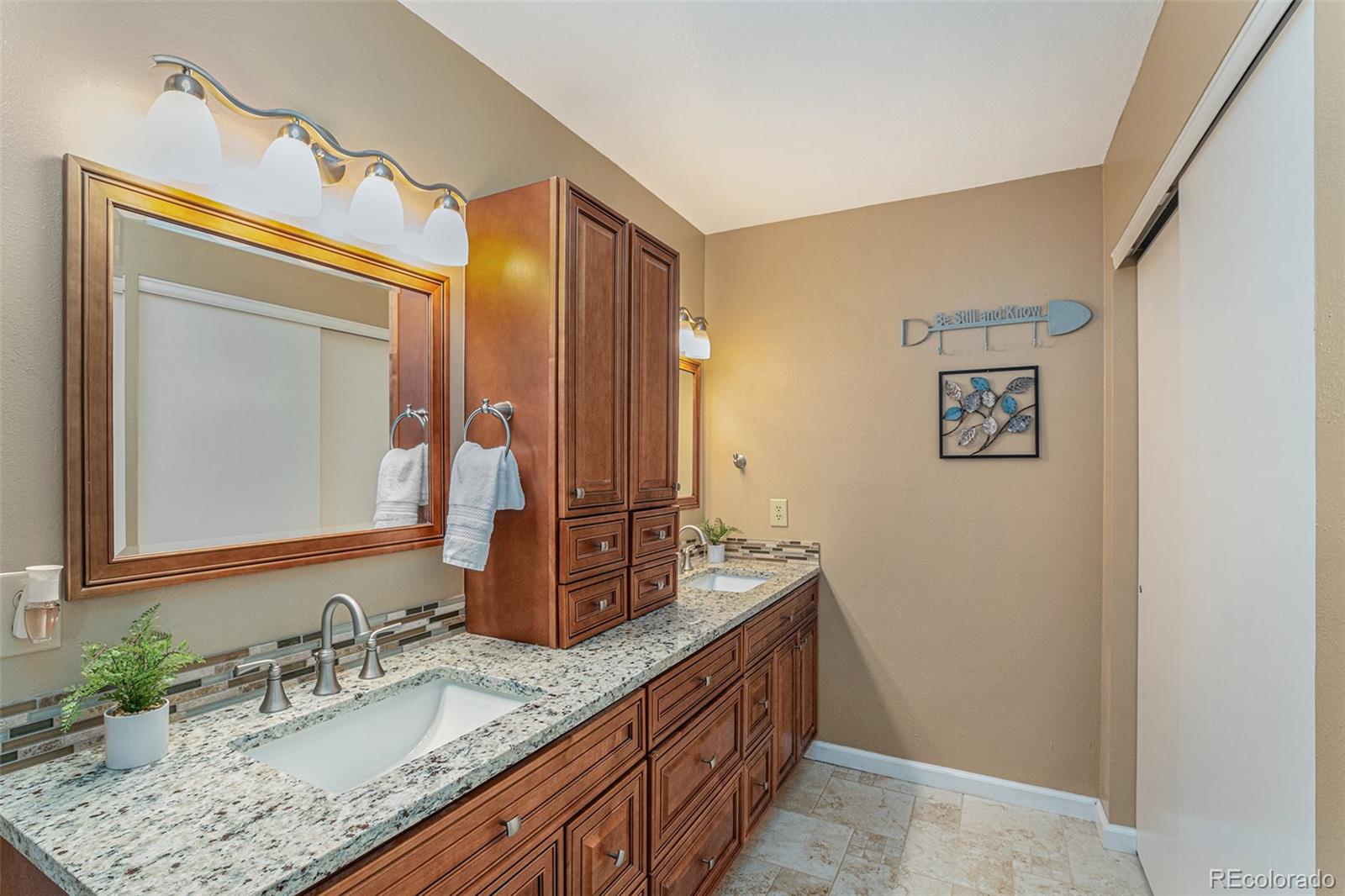 10110 Oak Street Westminster, CO 80021 - Photo 20 of 40 a bathroom with a granite countertop double vanity sink and a mirror