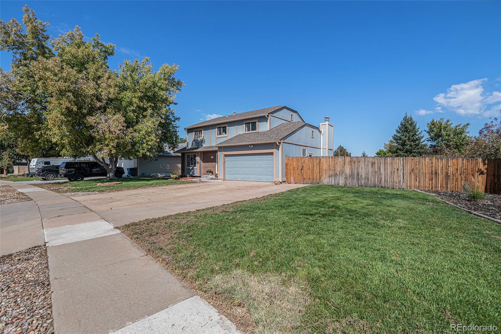 10110 Oak Street Westminster, CO 80021 - Photo 2 of 40 a front view of a house with yard