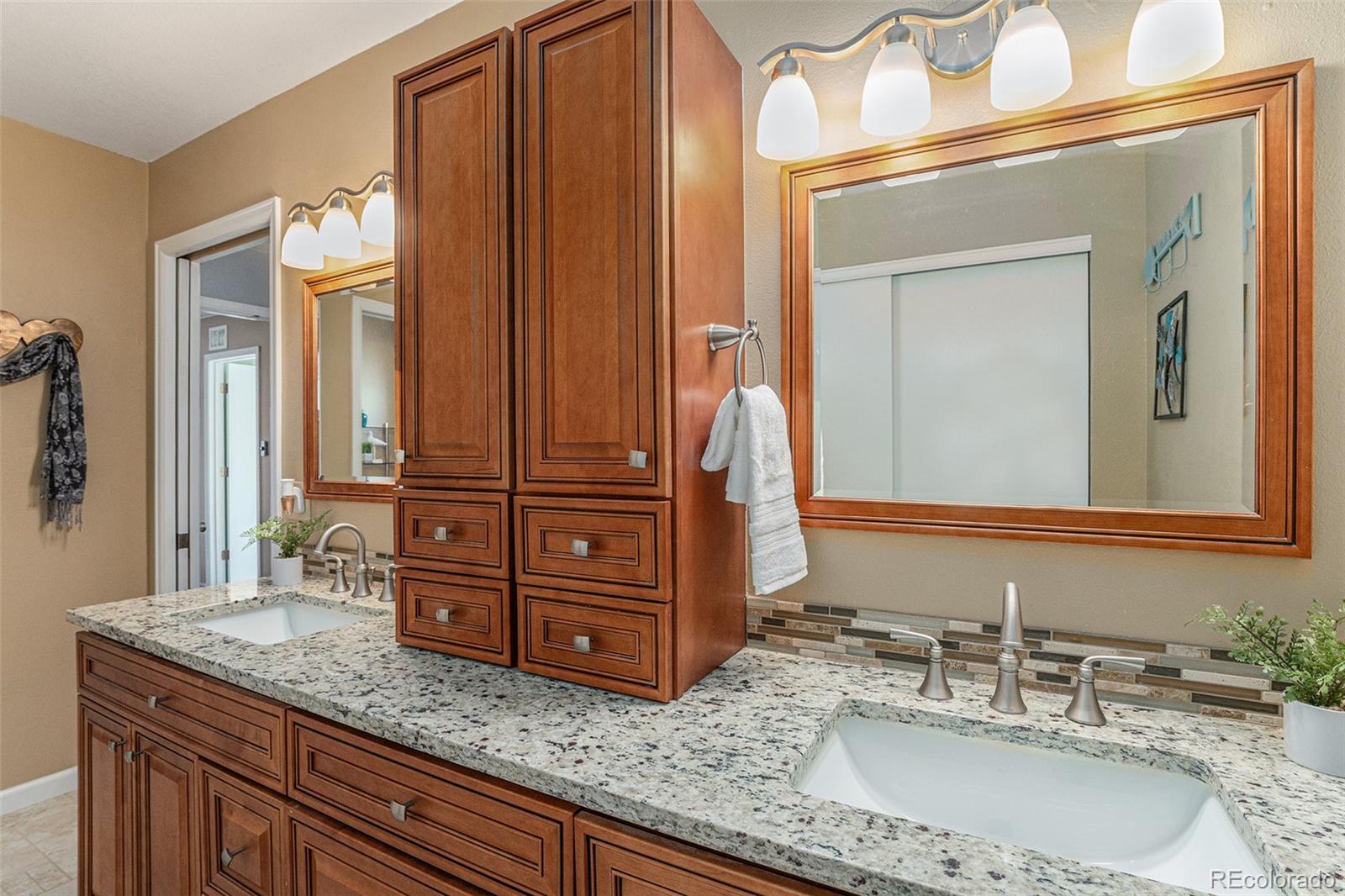 10110 Oak Street Westminster, CO 80021 - Photo 21 of 40 a bathroom with a granite countertop sink and a mirror