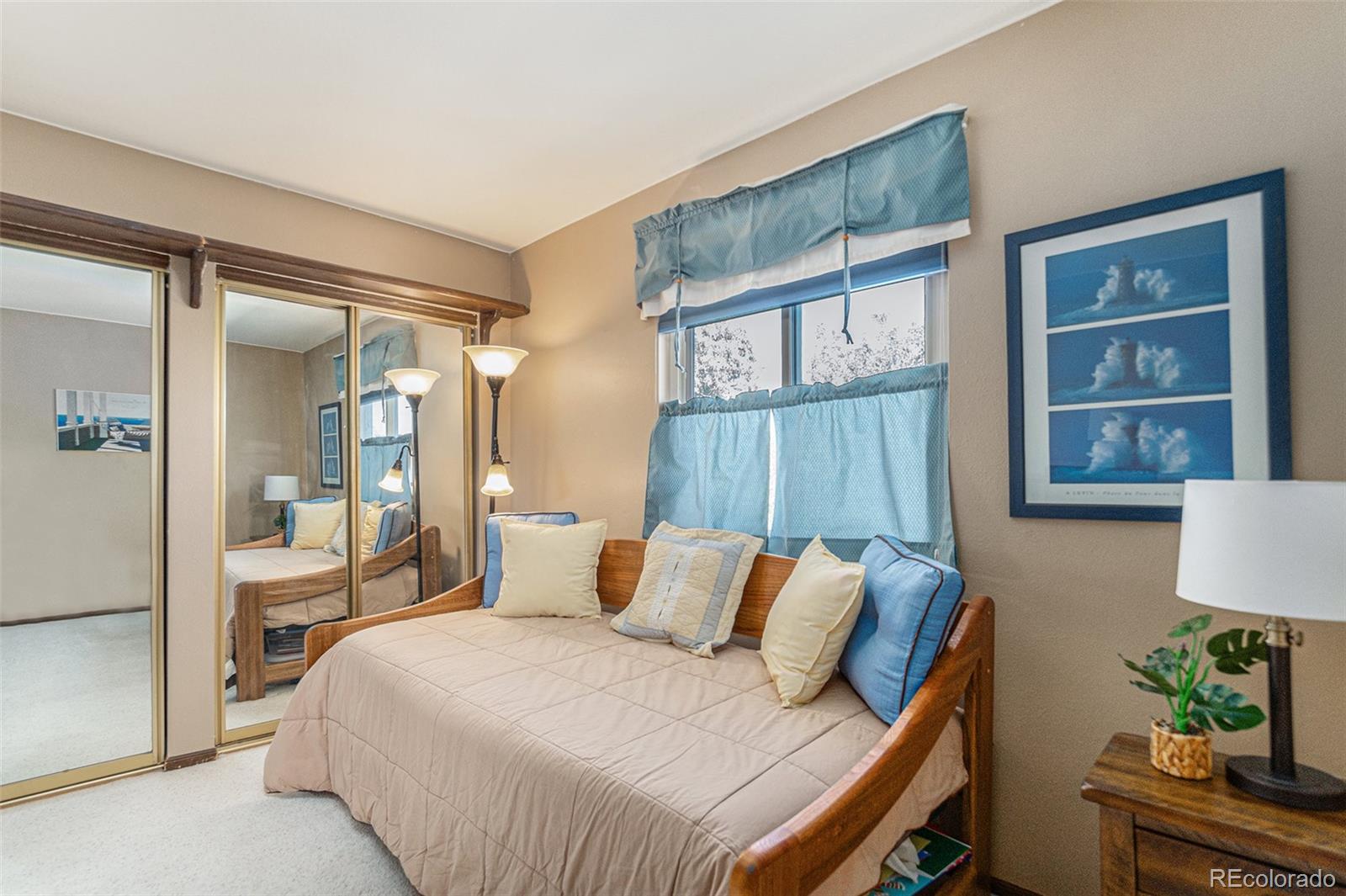 10110 Oak Street Westminster, CO 80021 - Photo 25 of 40 a bedroom with a bed window and potted plant on the dresser