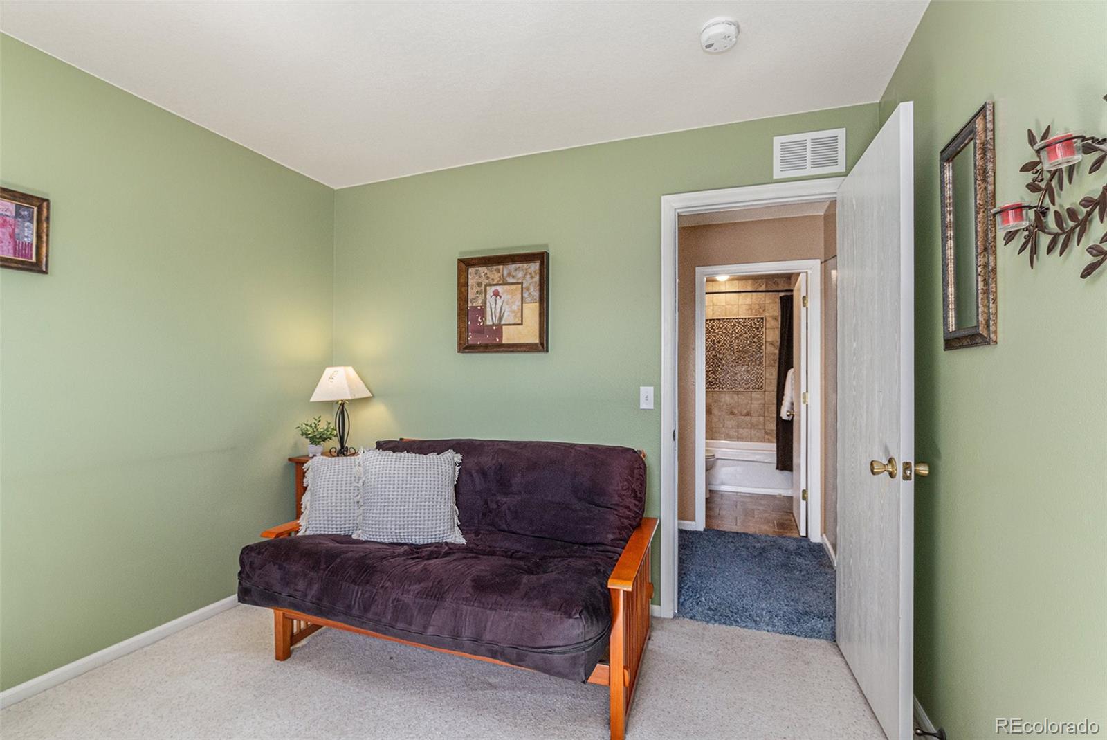 10110 Oak Street Westminster, CO 80021 - Photo 27 of 40 a living room with furniture and a painting on the wall