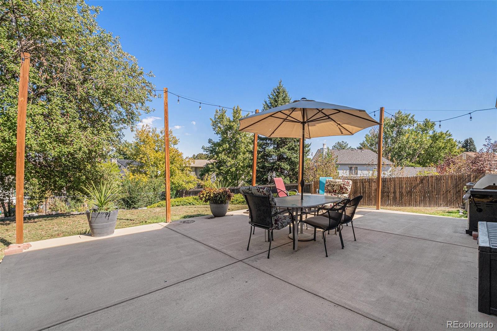 10110 Oak Street Westminster, CO 80021 - Photo 34 of 40 a view of a patio with a table and chairs under an umbrella