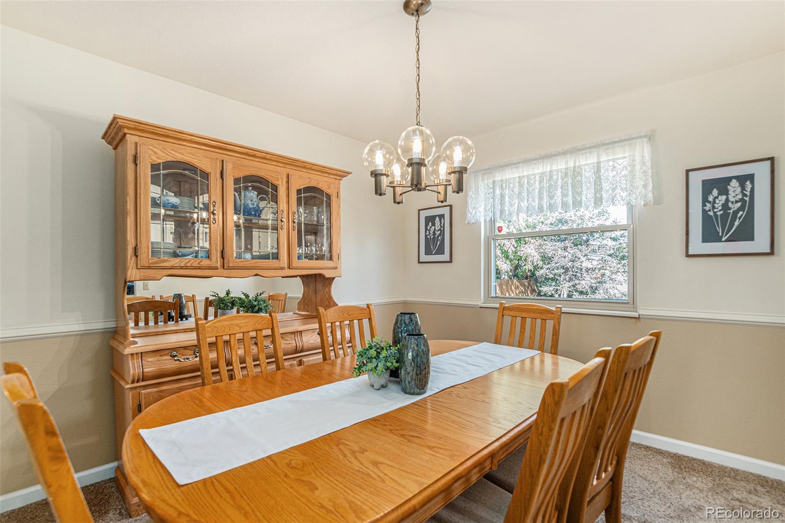 10110 Oak Street Westminster, CO 80021 - Photo 8 of 40 a view of a dining room with furniture a chandelier and wooden floor