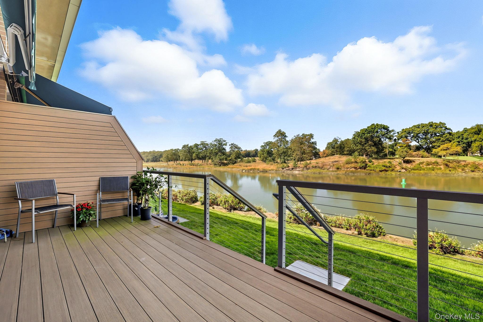 720 Milton Road, Unit H3 Rye, NY 10580 - Photo 19 of 27 a view of a balcony with wooden chairs and floor to ceiling window next to a yard
