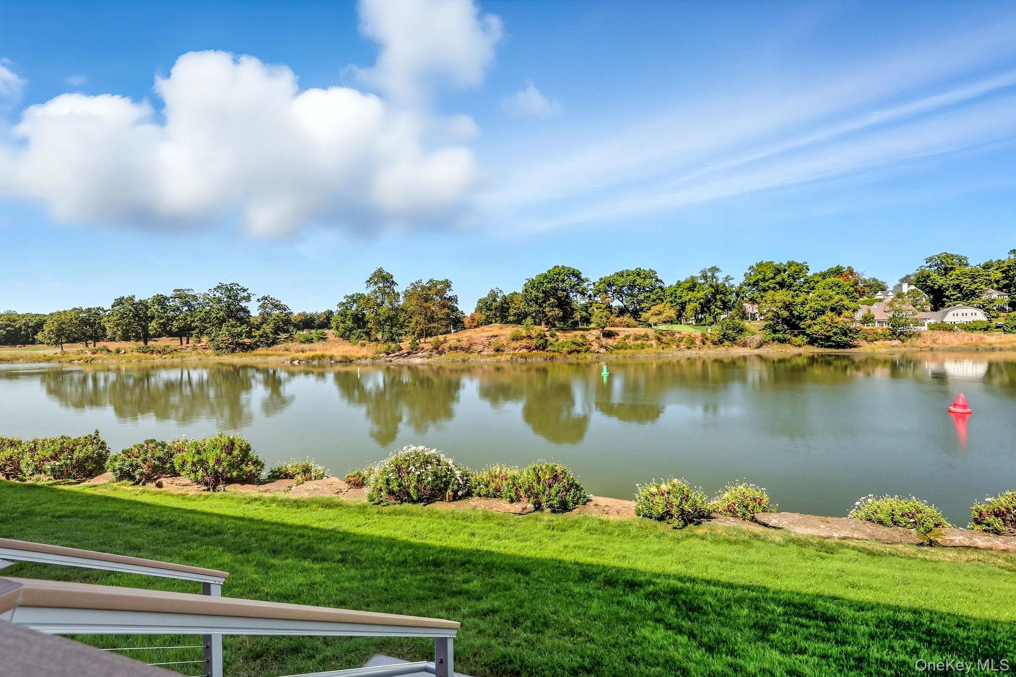 720 Milton Road, Unit H3 Rye, NY 10580 - Photo 20 of 27 a view of a lake with a yard