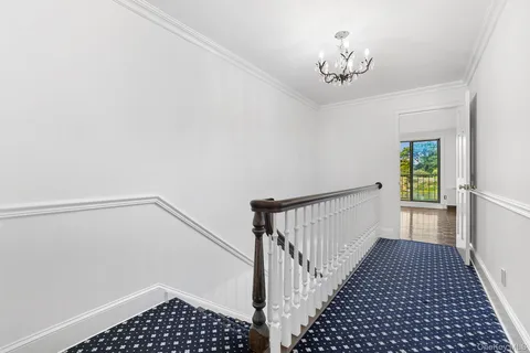 a view of a hallway with a chandelier