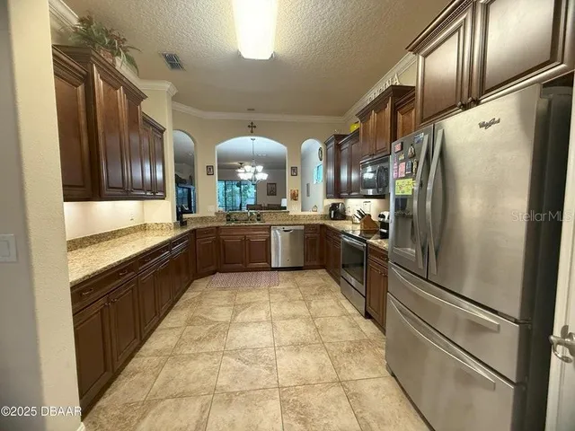 a large kitchen with cabinets and stainless steel appliances