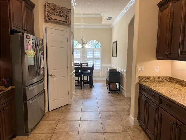 a kitchen with stainless steel appliances granite countertop a refrigerator and a stove