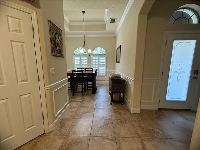 a view of living room with furniture and chandelier