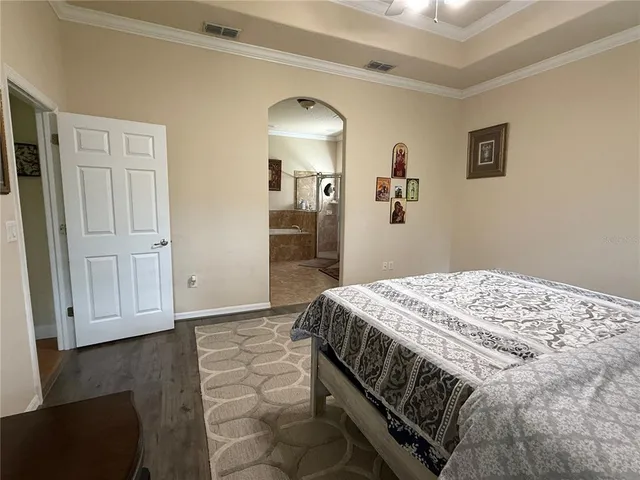 a bedroom with a bed and a mirror