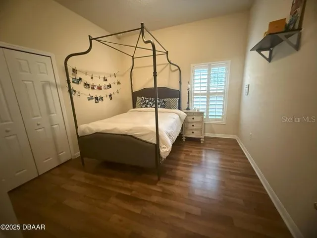 a bed sitting in a bedroom next to a window