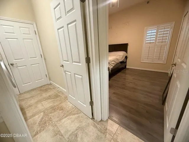 a view of a hallway view with wooden floor and staircase