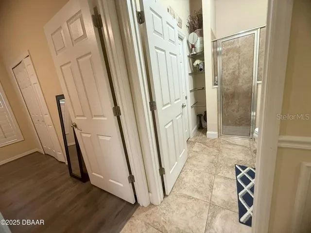 a view of a hallway with wooden floor and staircase