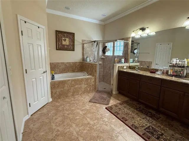 a bathroom with a tub a sink and a large mirror