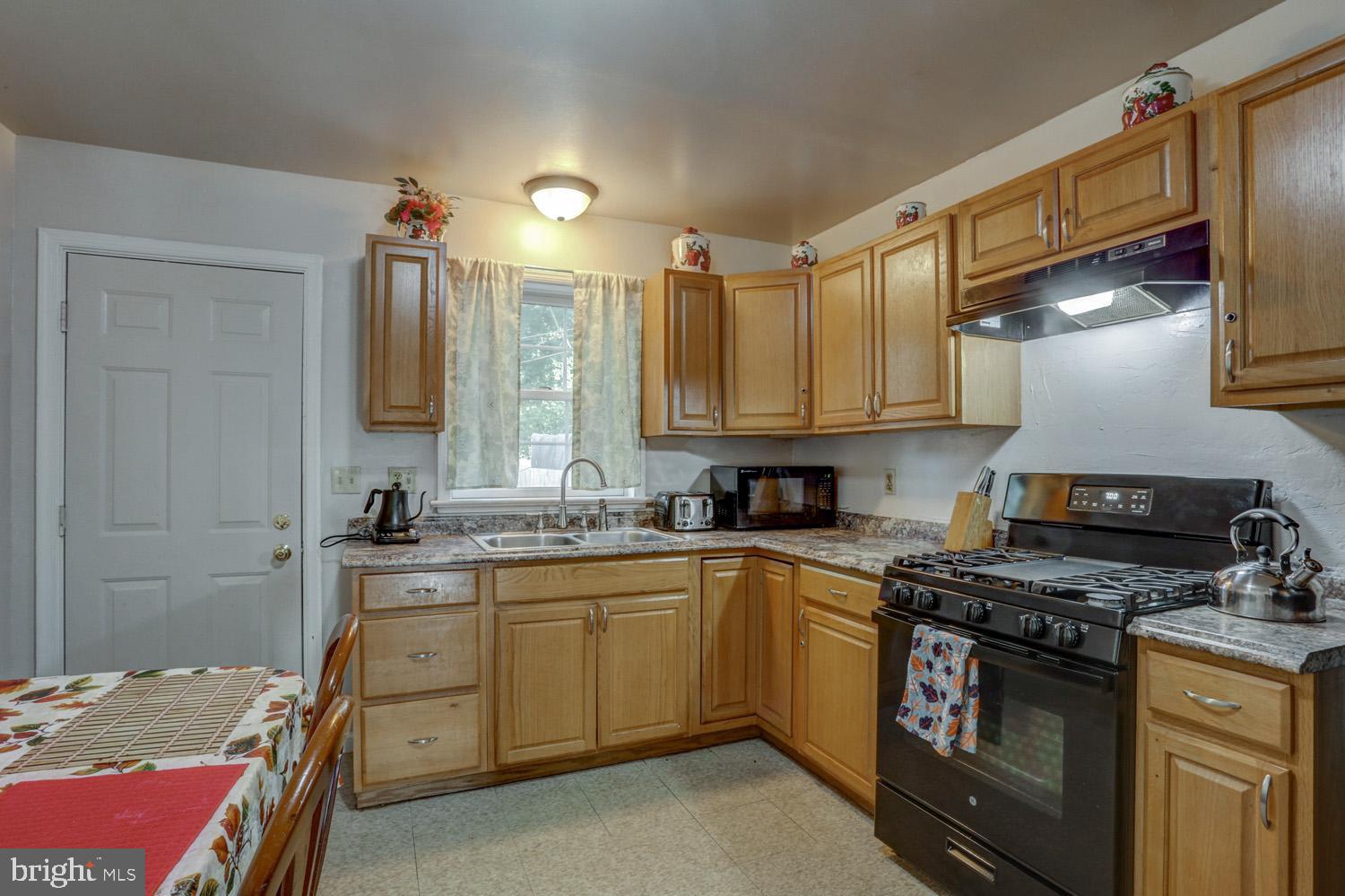 417 Green Street Lancaster, PA 17602 - Photo 18 of 37 a kitchen with stainless steel appliances granite countertop a sink stove and refrigerator