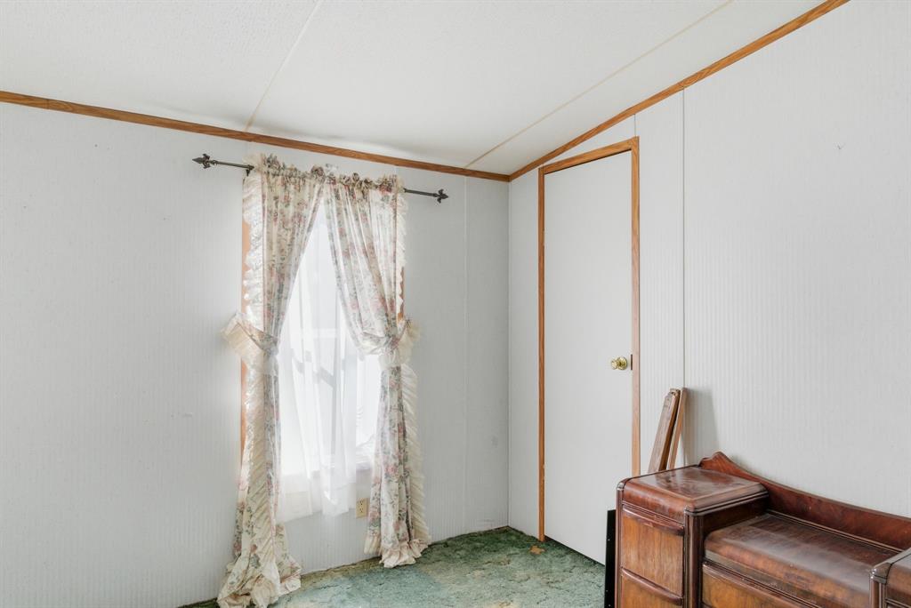 144 Oak Meadows Drive Springtown, TX 76082 - Photo 12 of 24 a view of a room with a water heater and stairs