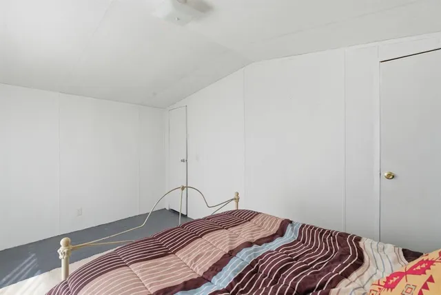 a bedroom with a bed and a table