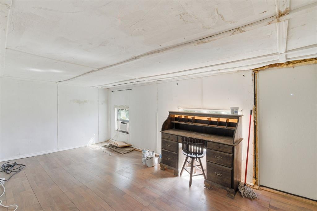144 Oak Meadows Drive Springtown, TX 76082 - Photo 18 of 24 a living room with a stove and wooden floor