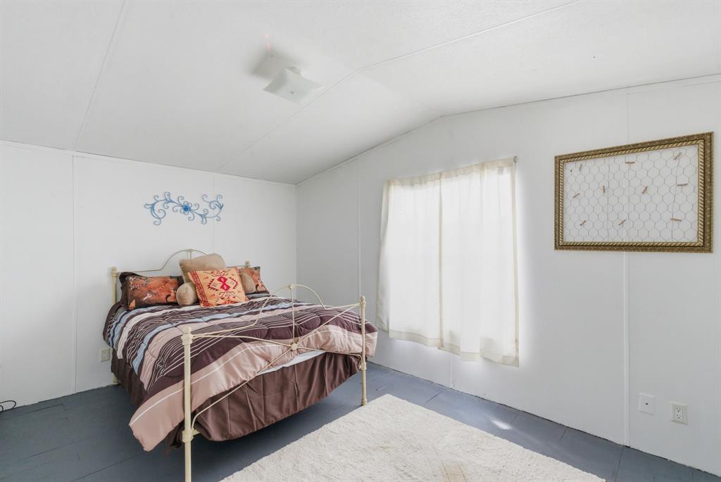 144 Oak Meadows Drive Springtown, TX 76082 - Photo 7 of 24 a bedroom with a bed and a window