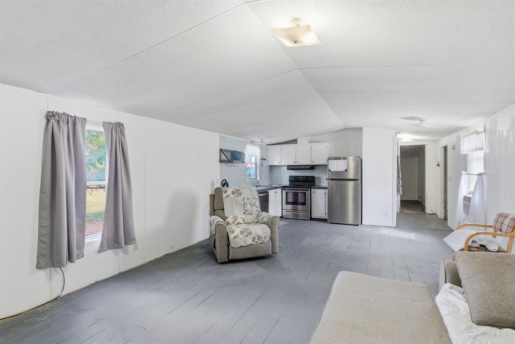 144 Oak Meadows Drive Springtown, TX 76082 - Photo 9 of 24 a living room with furniture and kitchen view