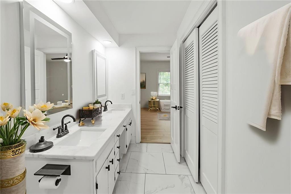 3649 Peachtree Road Northeast, Unit 305 Atlanta, GA 30319 - Photo 11 of 58 a bathroom with a sink double vanity and a mirror