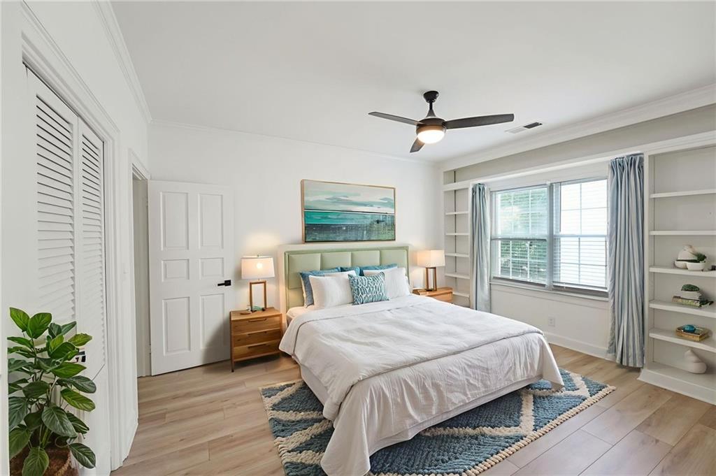 3649 Peachtree Road Northeast, Unit 305 Atlanta, GA 30319 - Photo 12 of 58 a bedroom with a large bed chandelier and a window