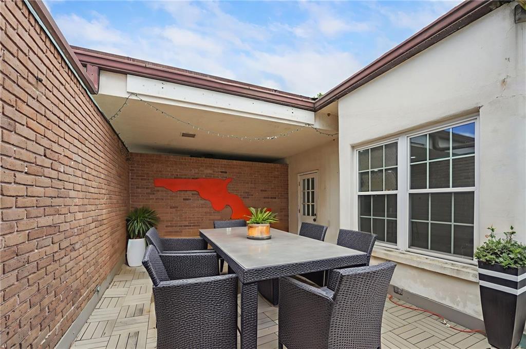 3649 Peachtree Road Northeast, Unit 305 Atlanta, GA 30319 - Photo 15 of 58 a view of a patio with table and chairs with wooden floor and plants