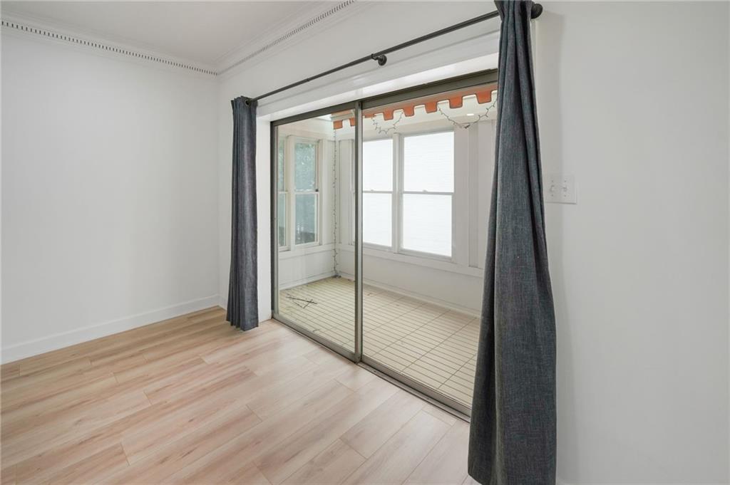 3649 Peachtree Road Northeast, Unit 305 Atlanta, GA 30319 - Photo 19 of 58 a view of an empty room with wooden floor and a window