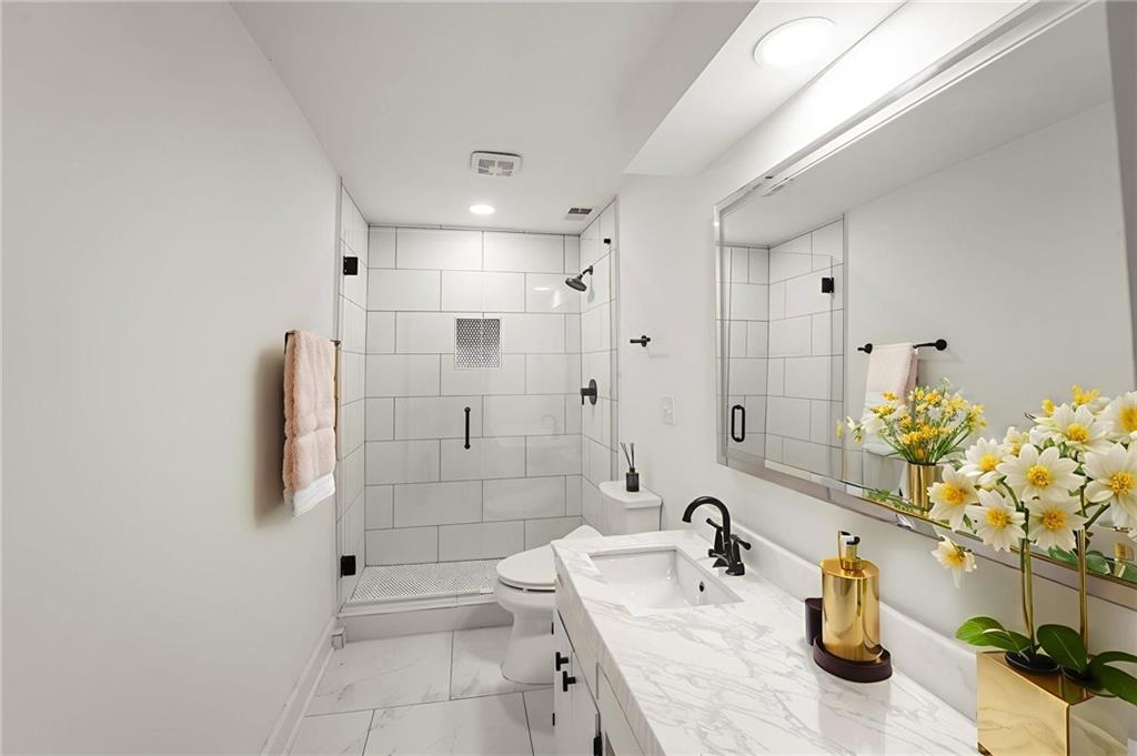 3649 Peachtree Road Northeast, Unit 305 Atlanta, GA 30319 - Photo 2 of 58 a bathroom with a sink a toilet and shower