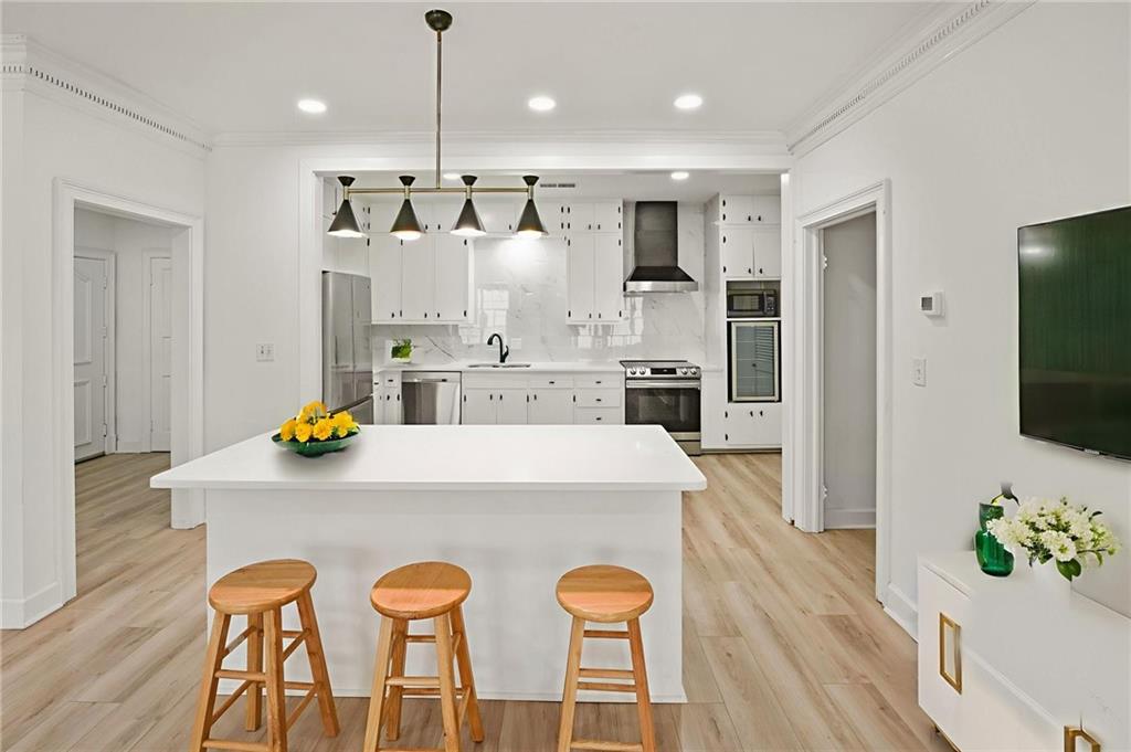 3649 Peachtree Road Northeast, Unit 305 Atlanta, GA 30319 - Photo 24 of 58 a large kitchen with a table and chairs