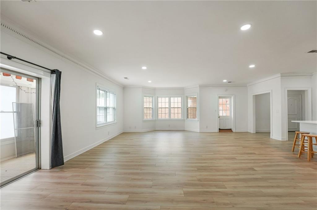 3649 Peachtree Road Northeast, Unit 305 Atlanta, GA 30319 - Photo 27 of 58 a view of an empty room with wooden floor and a window