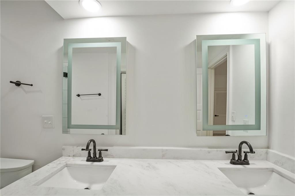 3649 Peachtree Road Northeast, Unit 305 Atlanta, GA 30319 - Photo 29 of 58 a bathroom with a sink and a mirror