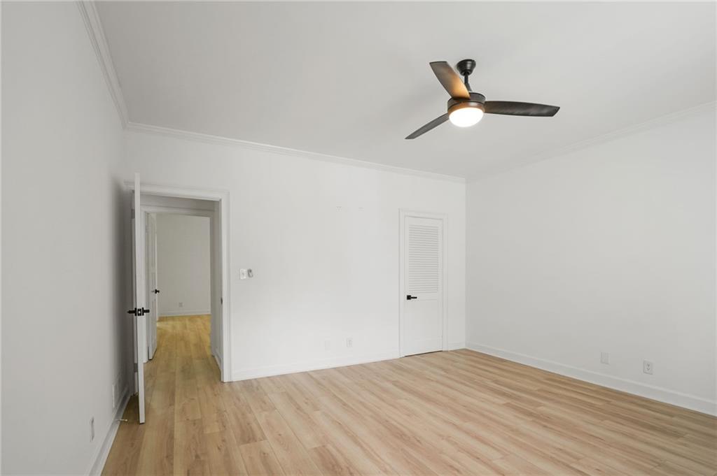 3649 Peachtree Road Northeast, Unit 305 Atlanta, GA 30319 - Photo 35 of 58 a view of empty room with wooden floor and ceiling fan