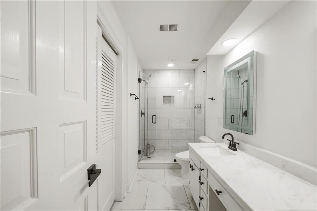 3649 Peachtree Road Northeast, Unit 305 Atlanta, GA 30319 - Photo 40 of 58 a bathroom with a tub sink double vanity granite tub shower and mirror