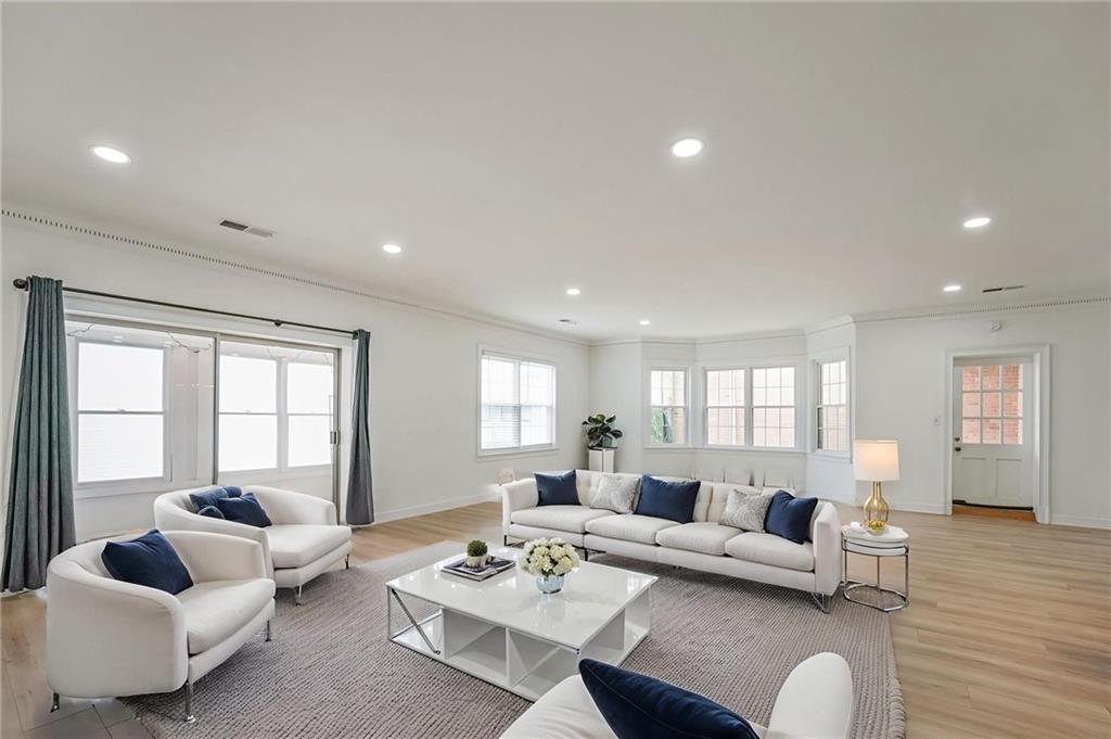 3649 Peachtree Road Northeast, Unit 305 Atlanta, GA 30319 - Photo 4 of 58 a living room with furniture and a large window